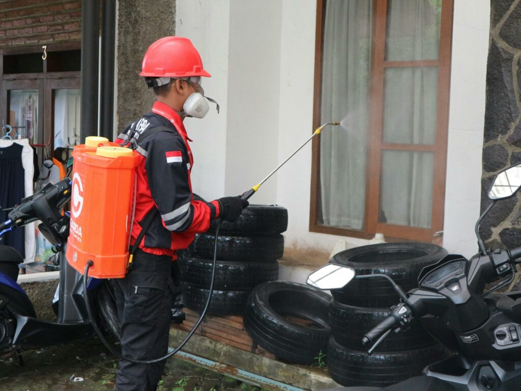 Man in Helmet Spraying Tires